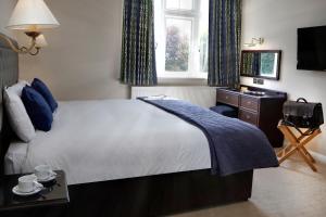 
A bed or beds in a room at Best Western Bestwood Lodge Hotel
