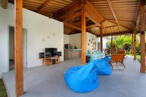 a large open living room with a blue cover at Villa Kaly by Optimum Bali Villas in Seminyak