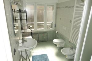 a bathroom with a sink and a toilet at Casa Solemare in Diano Marina