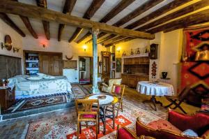a bedroom with a bed and a table and chairs at Sofa Hotel in Avanos