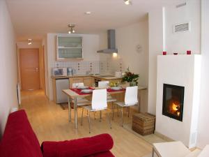 a kitchen and living room with a table and chairs at "schön-urlauben" in Gröbming