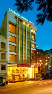 a large building with a sign on top of it at Bamboo Green Hotel in Da Nang