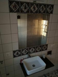 a bathroom with a white sink and a mirror at Ca' Vaschino in Granada +36 photos