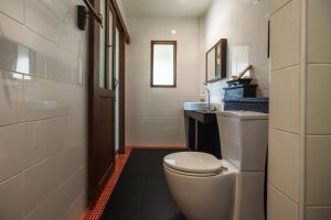 a bathroom with a white toilet and a sink at Cocohut Beach Resort Koh Phangan in Haad Rin