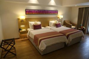 Sarovar Portico Rivera Ahmedabad客房内的一张或多张床位
