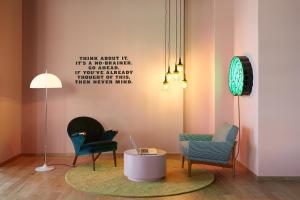 
a living room filled with furniture and a lamp at The Student Hotel Groningen in Groningen
