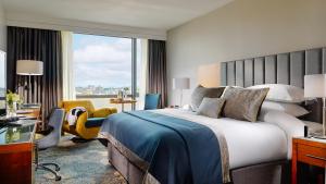 een hotelkamer met een bed en een groot raam bij Limerick Strand Hotel in Limerick