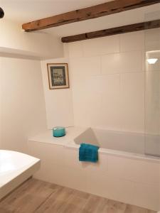 a white bathroom with a shower and a tub at Koege Guesthouse in Køge