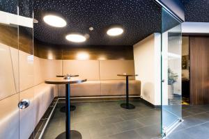 a small table in a room with a glass wall at Hof Veldink in Emlichheim +18 photos