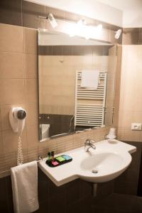 a bathroom with a sink and a mirror at Hotel Corte Business in Cavriago +38 photos