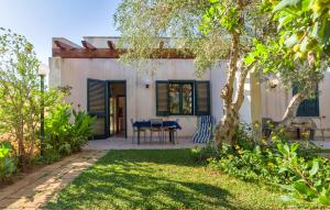 a house with a table and chairs in a yard at Lilybeo Village in Marsala