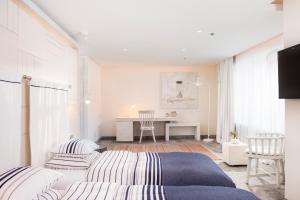 a white bedroom with a bed and a desk at D Resort Gocek Special Category in Göcek