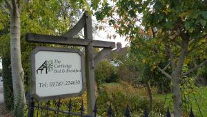 a sign for the carnegie backyards bar and barbecue at The Cartlodge B & B in Colchester