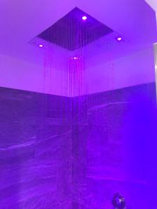 a purple room with a shower with purple lights at Albergo Quarto Pirovano in Passo Stelvio