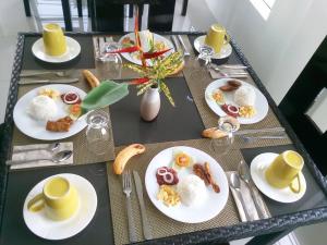 a table with plates of food on top at Abeth's Haven in Puerto Princesa City