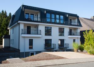 a white building with a black roof at Fichtenweg 31-S in Winterberg