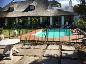 a house with a swimming pool in the yard at Howards End Manor B&B in Cape Town