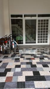 two motorcycles parked in a room with a checkered floor at Good Mood Cottage in Hengchun South Gate