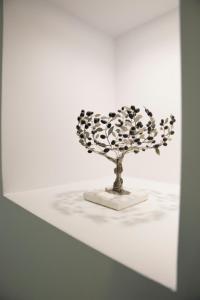 a sculpture of a flower on a white table at GK Athens in Athens