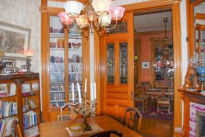 a dining room with a table and a chandelier at The Richards House in Dubuque