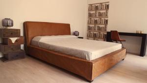 a bedroom with a bed and a book shelf at IndispArte Suites in Bergamo
