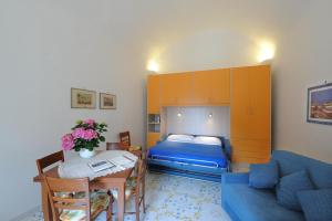 - une chambre avec un lit et une table avec un canapé bleu dans l'établissement Relais San Basilio Convento, à Amalfi