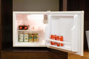 an open refrigerator filled with lots of food and drinks at Tara Place Hotel Bangkok in Bangkok