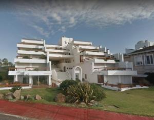 a large white building with many windows at Departamento Mar Punta del Este in Punta del Este