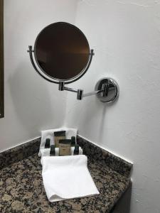 a bathroom with a mirror and a sink with towels at Hotel Chipinque in Monterrey +40 photos