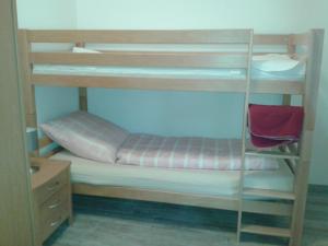 Etagenbett in einem Zimmer mit einem roten Stuhl in der Unterkunft Ferienhaus Poppe in Löningen