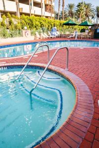 a swimming pool with two metal rails in the water at Kings Inn Anaheim at The Park & Convention Center in Anaheim