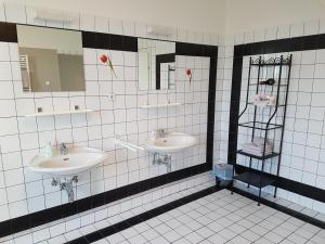 a bathroom with two sinks and two mirrors at Villa Sonnenschein in Laa an der Thaya