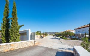 a street in a town with trees and a building at Kaladi Rock in Avlemonas