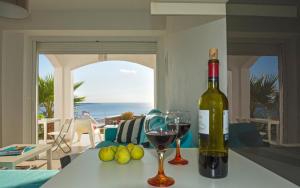 a bottle of wine sitting on a table with a glass at Kaladi Rock in Avlemonas