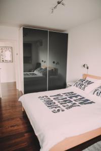 a bedroom with a white bed with a glass wall at Globetrotter in Zagreb