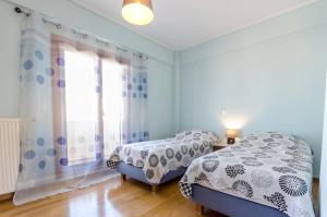 A bed or beds in a room at Leo - Unique Glyfada Apartment