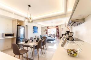 A television and/or entertainment centre at Leo - Unique Glyfada Apartment
