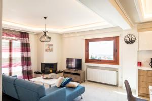 A television and/or entertainment centre at Leo - Unique Glyfada Apartment