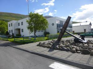 a pole sitting on the side of a road at Hotel Eskifjörður in Eskifjörður