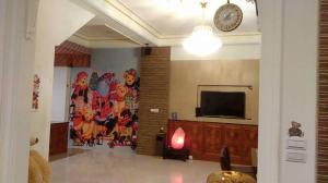 a room with a flat screen tv on a wall at Lambo Stay Inn in Toucheng
