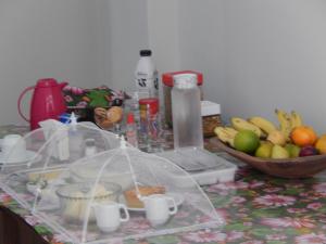 a counter with a bunch of fruits and a bowl of fruit at Suite Vista Mar in Salvador