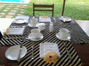 a table with a black and white striped table cloth at PJ's in Hikkaduwa