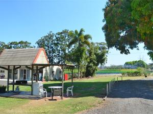 a picnic shelter with a table and chairs in a park at Beerwah Glasshouse Motel in Beerwah