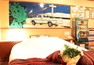 a bedroom with a large picture of a truck on the wall at Pal Annex Ogawa in Kumamoto +13 photos