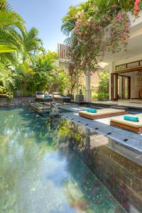 a swimming pool in the middle of a house at Villa Kipas in Seminyak