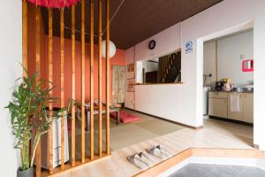 a living room with a staircase in a house at Yukiya in Osaka