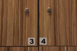 a pair of wooden doors with numbers on them at Mama Africa Hostel in Florianópolis