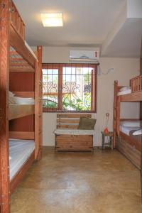 a room with two bunk beds and a window at Mama Africa Hostel in Florianópolis