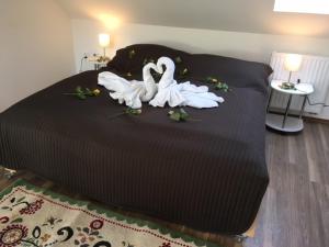 a bed with three white swans sitting on it at Apartmány Comfort in Střílky