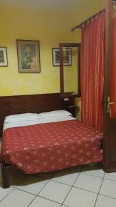 una camera con un letto con copriletto rosso di Sa Colonia Chia a Chia